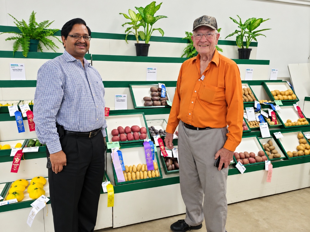 Dr. Florian Lauer and Sanjay Gupta at the Minnesota State Fair potato display